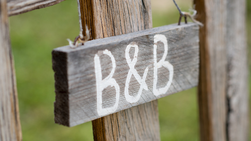 Hanging wooding sign that says B and B